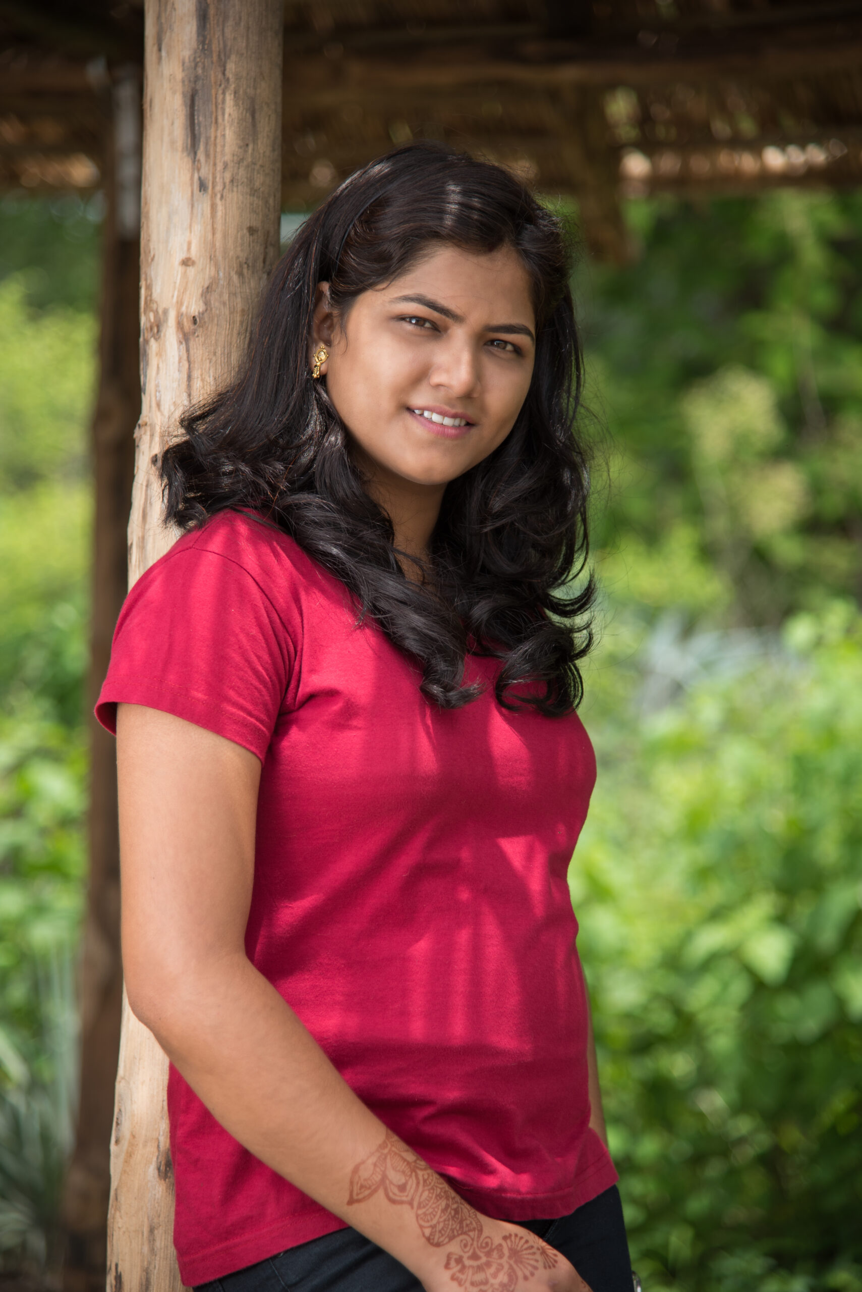 smiling woman in red shirt posing outdoors 2026 03 26 06 21 54 utc